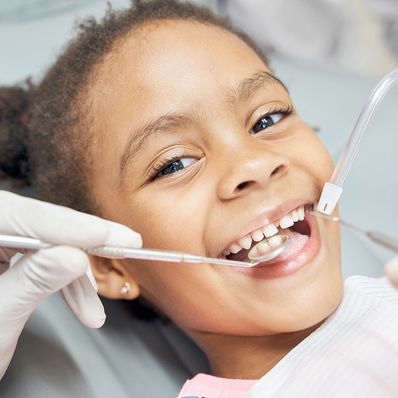 child getting dental cleaning